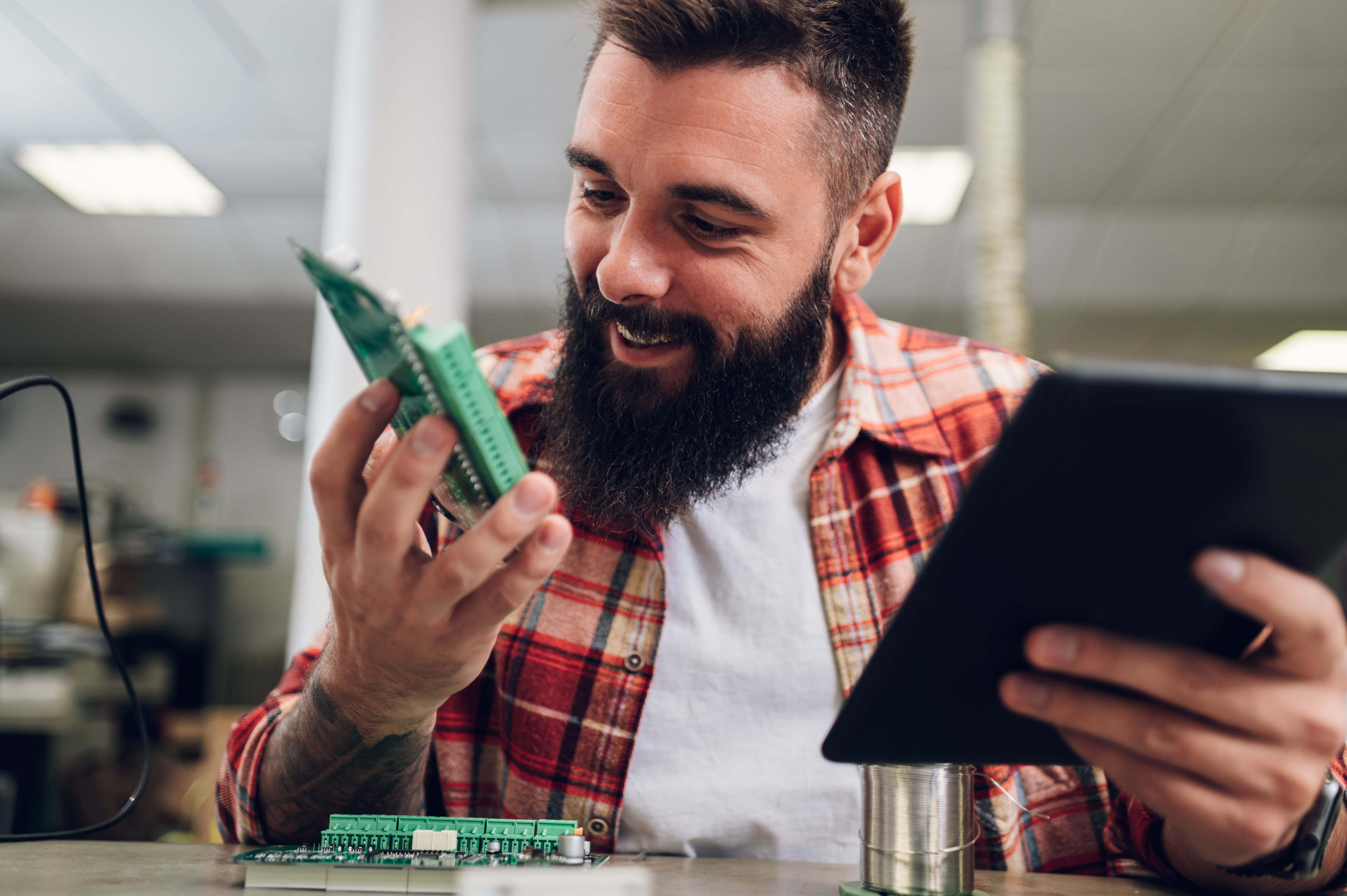 Man looks at circuit boards