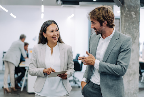 Two business people walking and talking